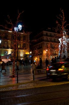 LISBON, PORTUGAL - DECEMBER 19: moving cars traffic and people in motion next to Luis Vaz de Cam�es square during Christmas time on December 19, 2011 in Lisbon, Portugal