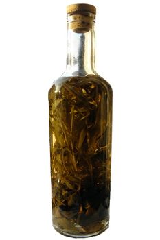 Photo of a bottle of vinegar with herbs. Provided free object.