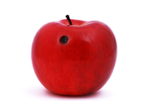 red apple with a ruffled hole on a white background