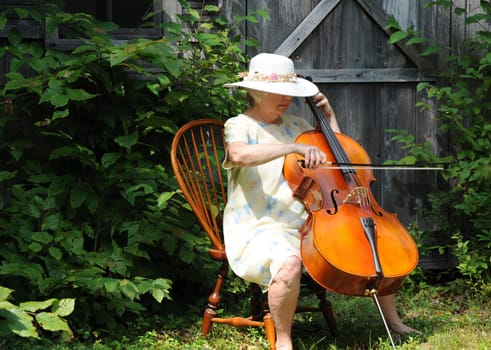 Female cellist performing outdoors.