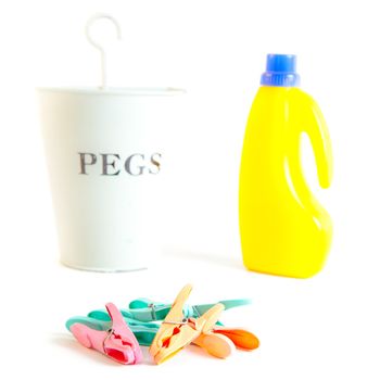 Colorful plastic clothes pegs on a white background