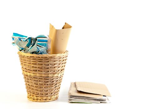 A waste paper bin on a white background