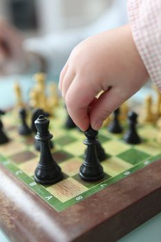 Close-up of toddler playing chess