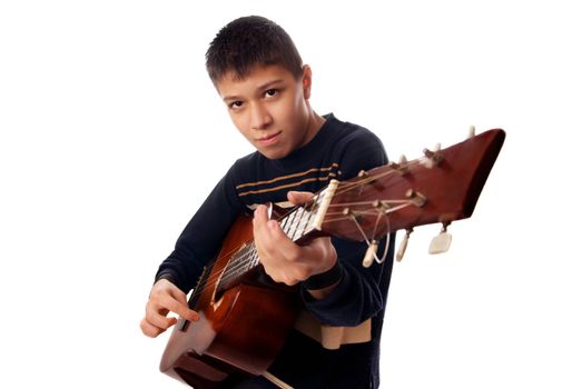 Studio photo of young boy playng guitare