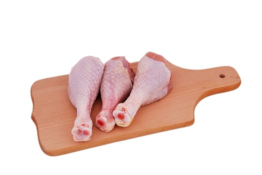 chicken drumstick on the board on a white background