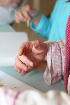 Children with paint covered fingers