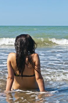 Girl on a deserted beach in a bay in Ecuador