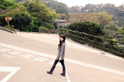 Stylish asian woman in a park