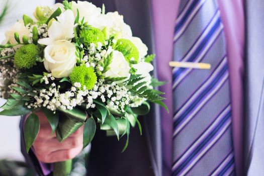 Man hold bouquet in hand