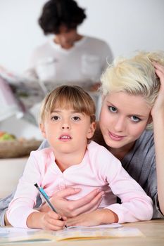 Mother helping daughter with homework