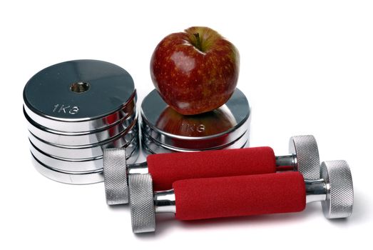 Barbells and apple isolated on white background