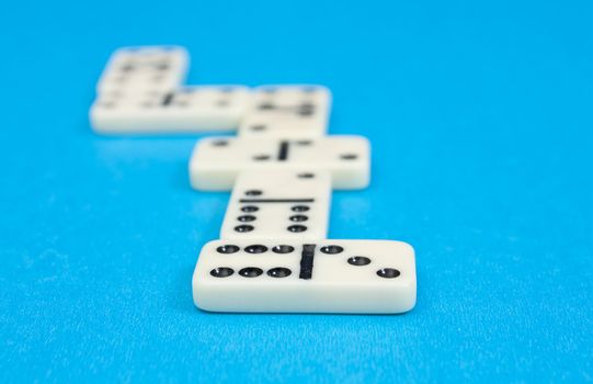 Closeup photo of domino bricks on blue background
