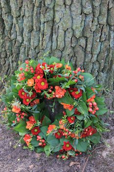 Mixed red flowers in a sympathy flower arrangement