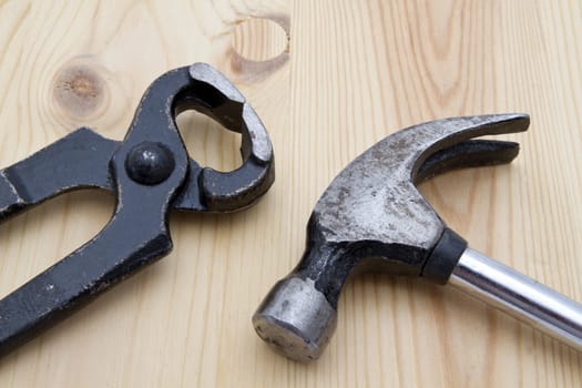 Old wrench and hammer closeup on wood background 

