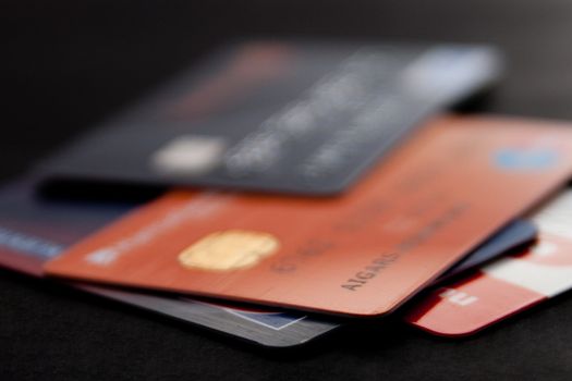 stack of credit cards on a black background