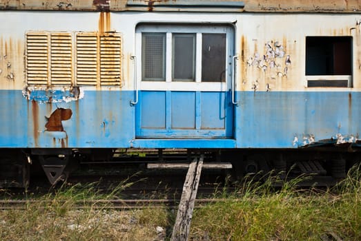 Old and decommissioned train cabin on train yard
