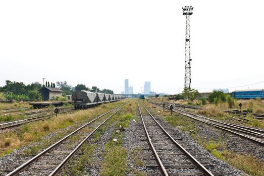 Multiple railway line with freight train on the left
