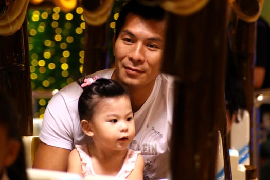 HONG KONG - OCT 3, Father and his daugher in playground in Hong Kong on 3 October, 2010. They are typical Hong Kong people at weekend.