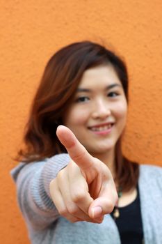 Asian woman pointing 