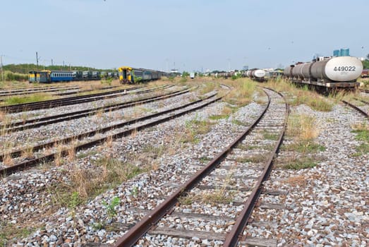 Large railway yard landscape with train on the right, taken on the sunny afternoon
