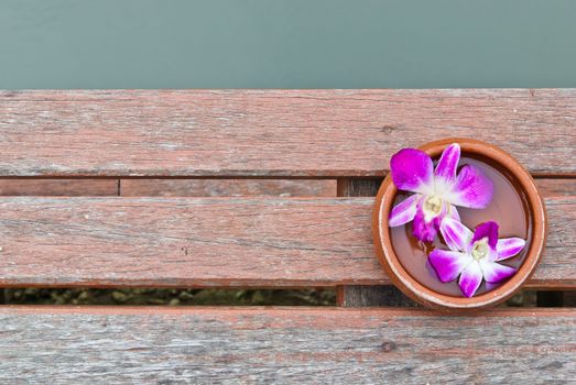 Thai orchid on wood platform with water on top, can be use for health and beauty related concepts
