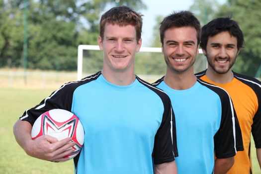 portrait of 3 football players