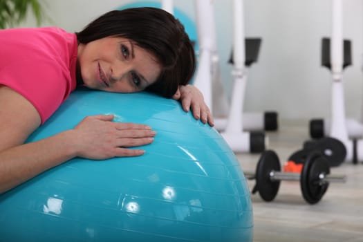 woman doing exercises with a ball