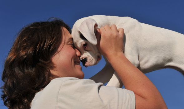 young woman and her best friend purebred puppy white boxer