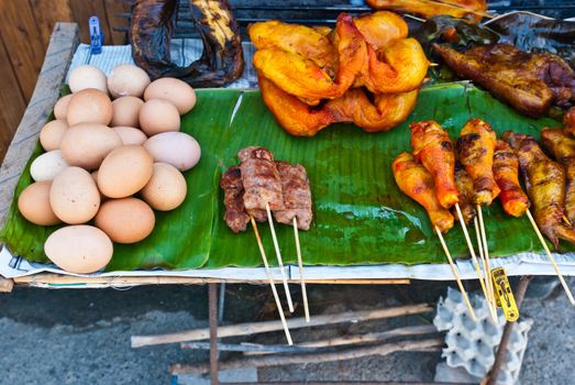 Various flamed grill bbq food including, chicken, pork, eggs