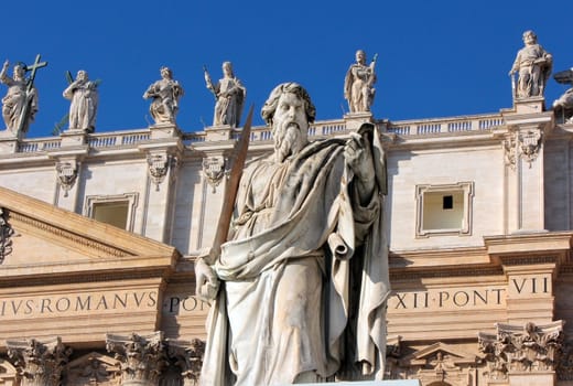 statue of Apostle Paul in St. Peter's Square with blue sky background, Rome, Italy