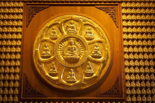 Golden chinese buddha statue on wood