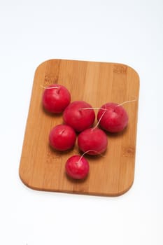 Garden radish on wooden board 