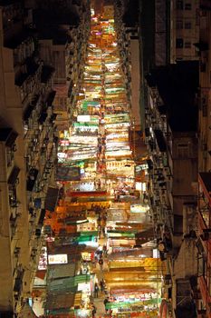 HONG KONG - FEB 9, Temple Street with many booths and tourists walking through in Hong Kong on 9 Feburary, 2011. It is the busiest flea markets at night in the territory.