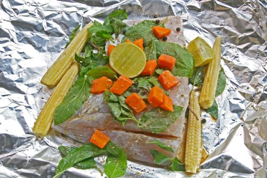 Preparation of Raw White sea bass with herb,corn carrot sweet basil and lime in Traditional Thai Style