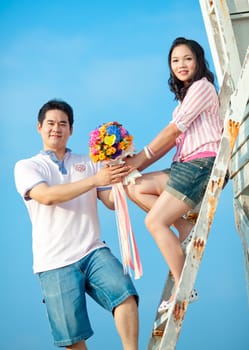 couples holding beautiful flowers bouquet together on the beach