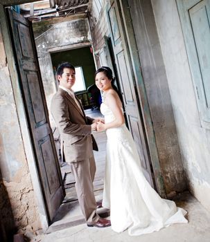 couples of groom and bride portrait in old church after wedding ceremony