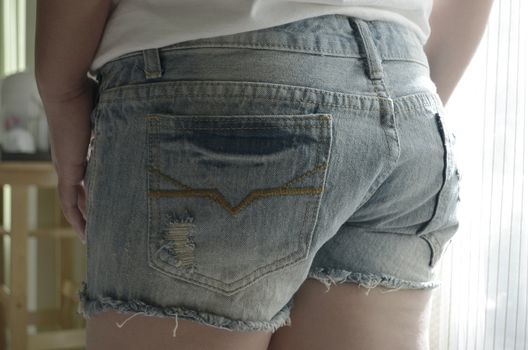 close up of beautiful young woman wearing denim short shorts