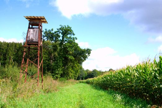 hunter tower with corn fileds on blue sky