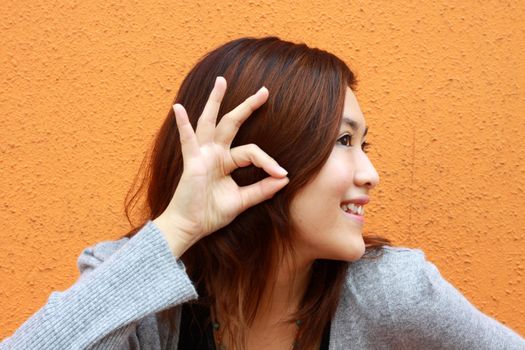 Asian woman hearing voice