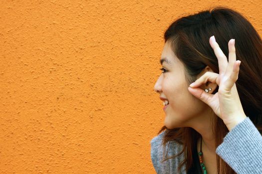 Asian woman hearing voice