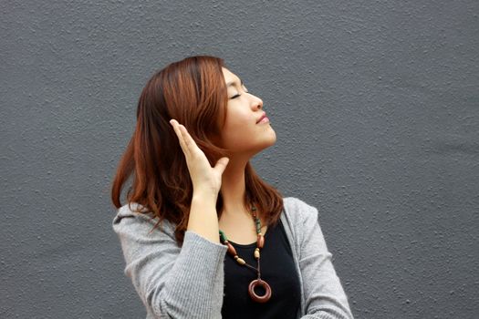 Asian woman hearing voice