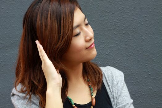 Asian woman hearing voice