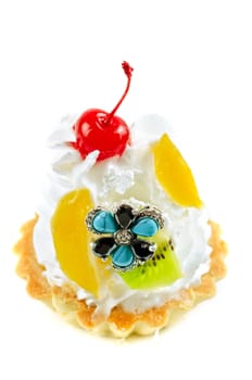 cupcake and bijouterie flower on a white background
