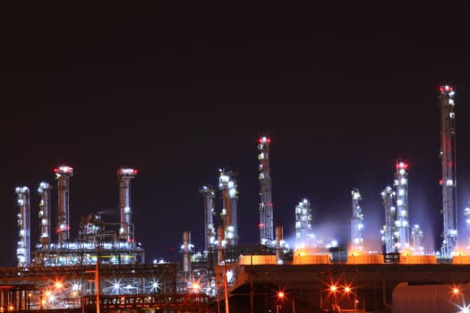 beautiful scenic of petrochemical oil refinery plant shines at night, closeup