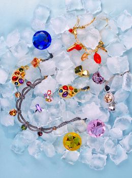 Jewels at blue cube of ice background