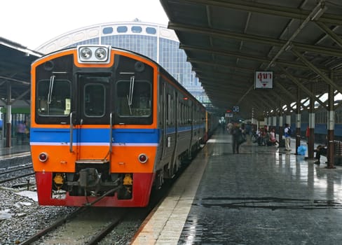 Red and Orange Train coming to Bangkok Station Thailand