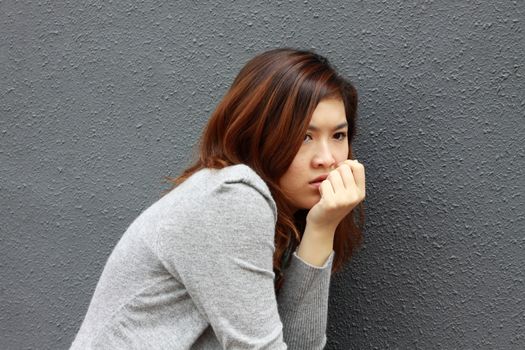 Asian woman with frightened face