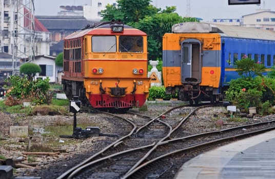 Red Yellow Diesel Engine Train locomotive approaching to Bangkok Railway Station Thailand