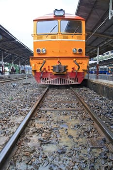 Deisel Engine of Red orange train, Diesel locomotive, on Bangkok railway station platform Thailand