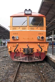 Closeup of Yellow diesel train locomotive on Platform of Bangkok Railway Station Thailand.